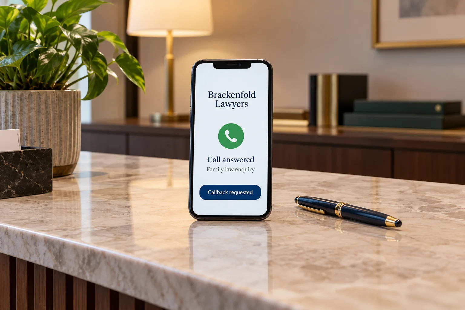 A phone on a reception desk showing a Brackenfold Lawyers call answered concept