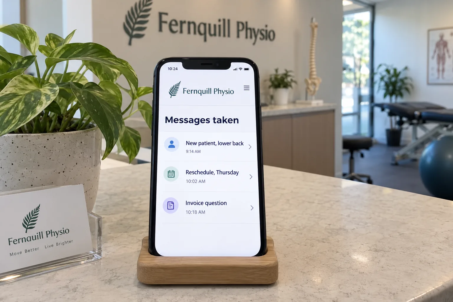 A phone on a clinic counter showing a Fernquill Physio messages taken screen concept