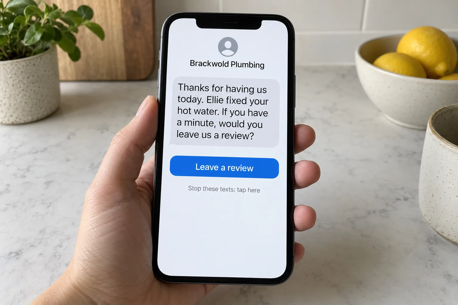 A phone showing a Brackwold Plumbing review request text concept