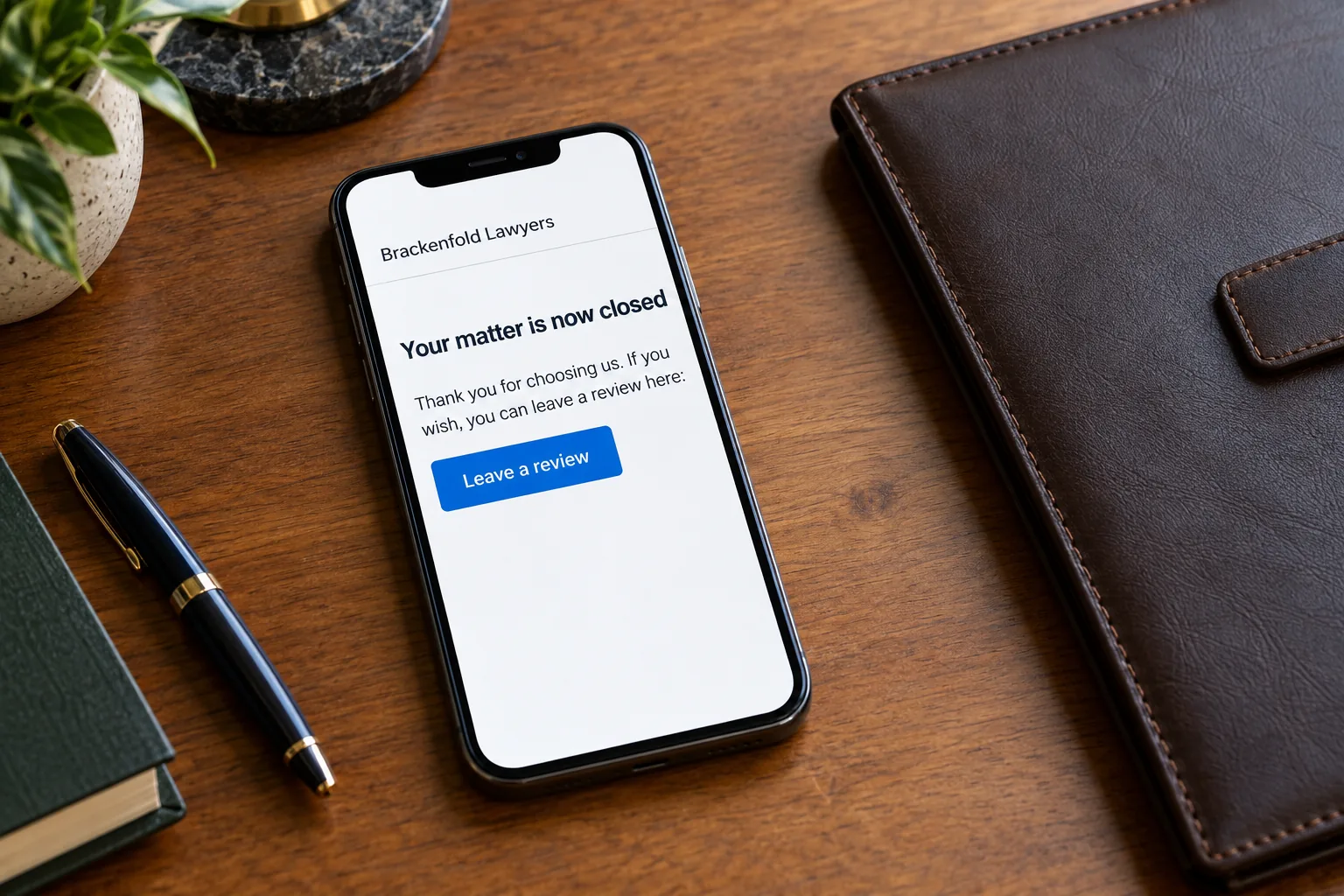 A phone on a desk showing a Brackenfold Lawyers matter closed review request concept