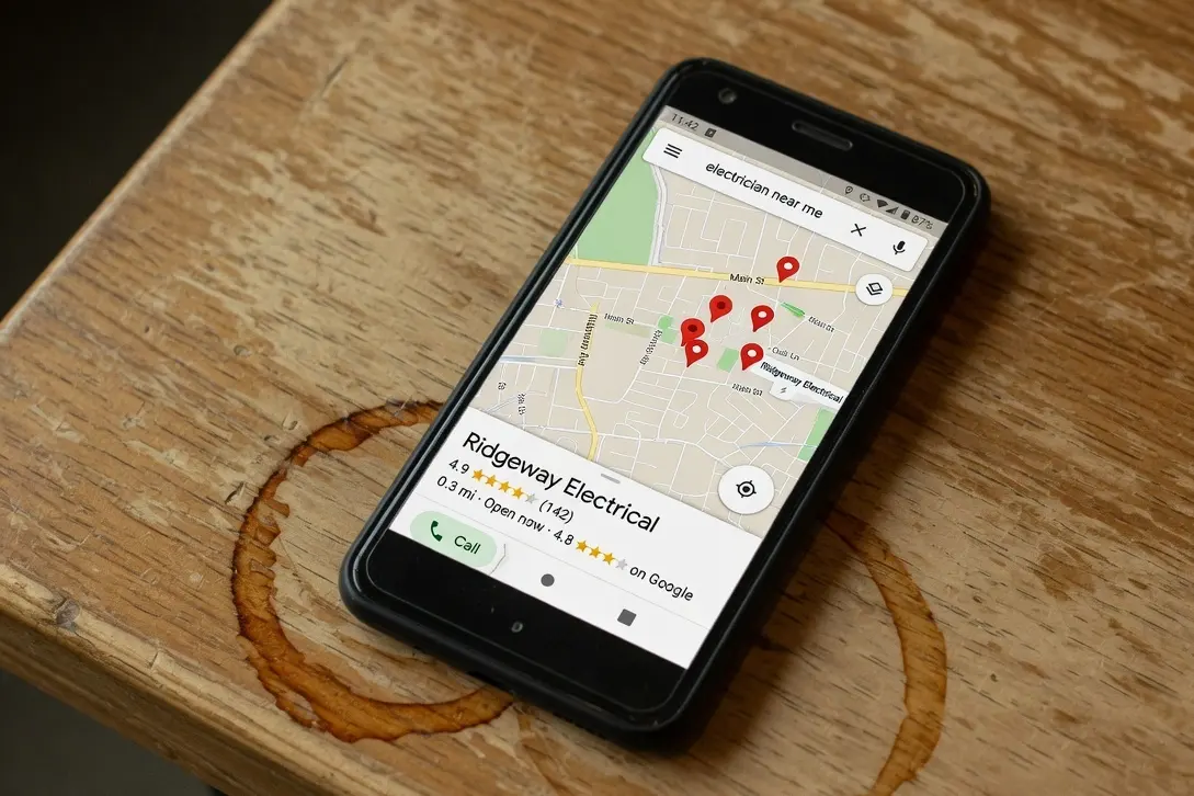 A phone showing a Google Maps search concept for an electrician