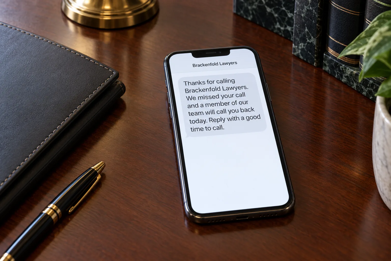 A phone on a desk showing a Brackenfold Lawyers missed-call callback text concept