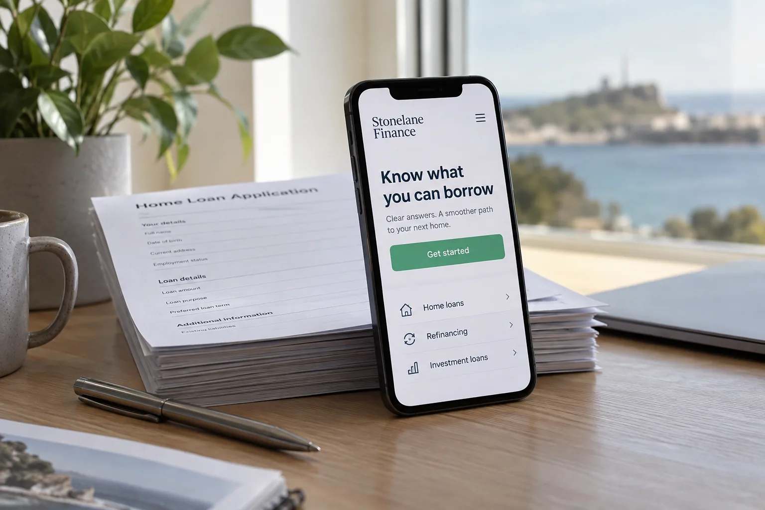 A phone propped on loan papers showing a mortgage broker website
