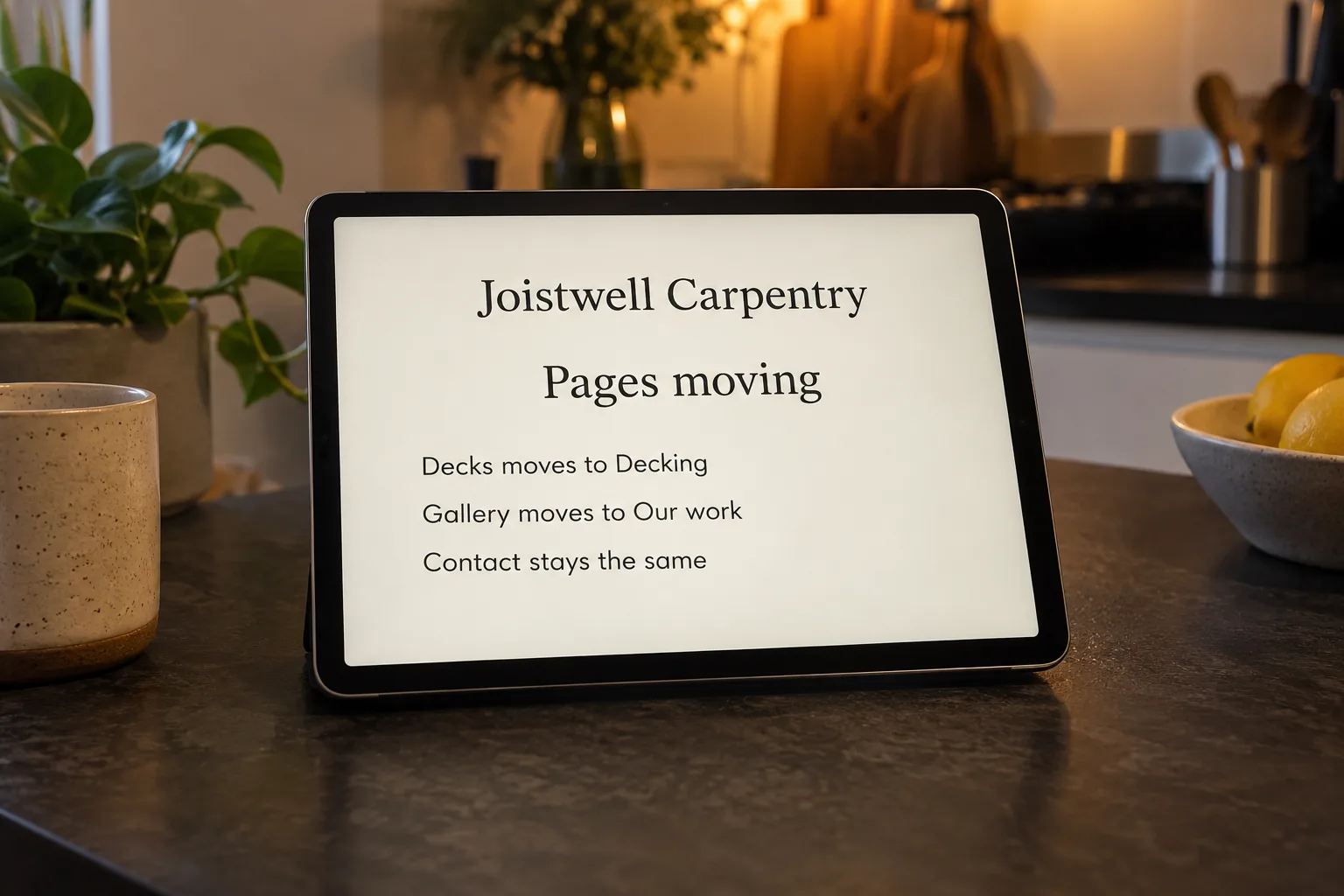 A tablet on a kitchen bench showing a Joistwell Carpentry list of pages moving to new addresses concept